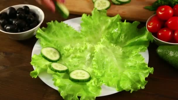Woman Puts Sliced Cucumbers White Plate Close — Stock Video