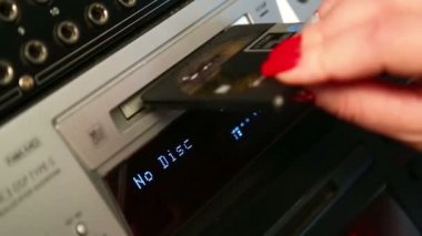 Bir kadın bir mini disk oyuncu ekler.