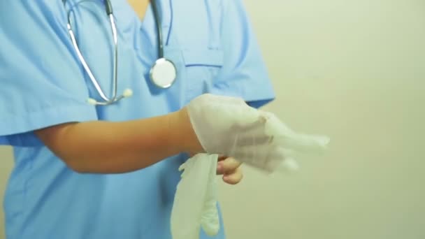 Vrouw van de dokter oplegt medische handschoenen in handen voor de operatie. — Stockvideo