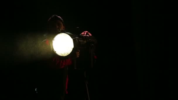 Young Woman Illuminator Directs Beam Light Spotlight — Stock Video