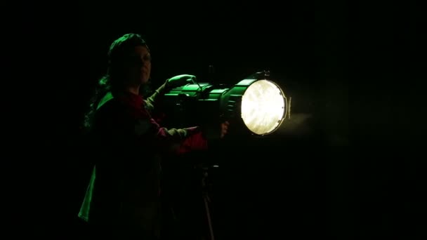 Young Woman Illuminator Directs Beam Light Spotlight — Stock Video