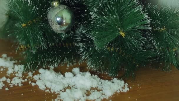 Vrouwelijke hand. Hand siert een kerstboom door imitatie van sneeuw — Stockvideo