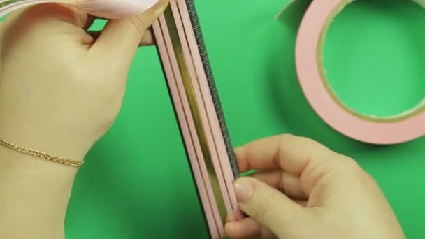 Manos Femeninas Envolviendo Patrón Cinta Rosa Sobre Fondo Verde Hecho — Vídeos de Stock