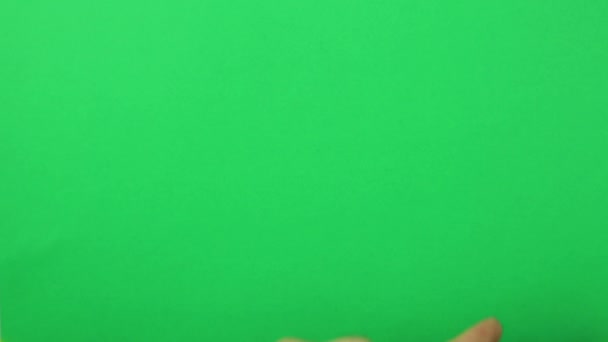 Male hand on a green background with a raised index finger. — Stock Video