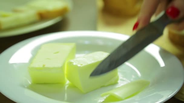 Een Vrouw Snijdt Een Plak Van Boter Uitstrijkjes Brood Voor — Stockvideo