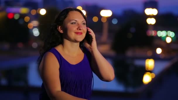 Young Woman Blue Dress Talking Smartphone Background Street Lights Blurred — Stock Video