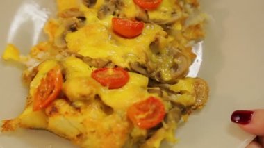 Altında mantar ve beyaz tabakta domates peynir pişmiş balık