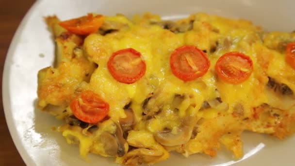 Baked fish in cheese with mushrooms and cherry tomatoes. — Stock Video