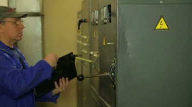 Elektrikçi mühendis elektrikli ev aletleri okuma disk kaydeder.