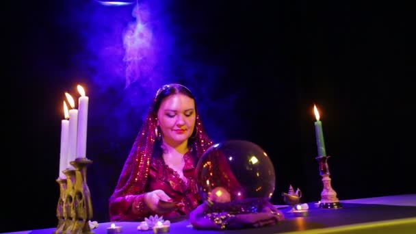 A young gypsy woman in red fortune tellers with cards — Stock Video