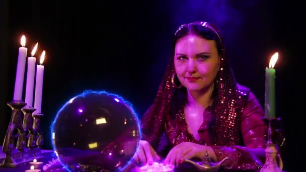 Une jeune gitane accomplit des rituels magiques sur une boule scintillante de foudre et de pierres — Video