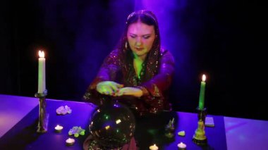 Büyülü salonda çingene parlama ve duman çevrili bir sihirli top gelecekte okur.