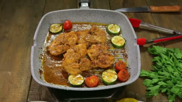 Chicken with vegetables is fried in a grill pan — Stock Video