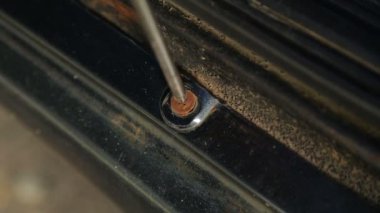 Tornavidayı olan bir adam otomobilleri koruma bağlantı elemanı.