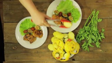 Bir WOMANS el bir salata kase bir ızgara Pan bir hazır tavuk içine sebze koyar. Zaman turunda