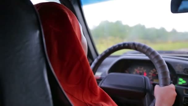 Mladá stylová muslimka v hidžábu za volantem auta. Zezadu — Stock video