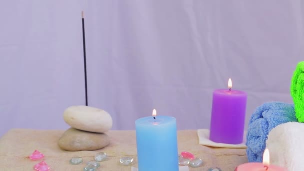 Spa salon with candles, towels and stones for therapy — Stock Video