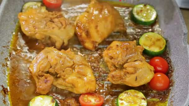 Female hand checks the readiness of meat on a grill pan. — Stock Video