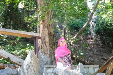 Dağa tırmanırken platformda dinlenen genç kadın turist.