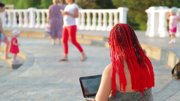 Genç tabaklanmış kadın serbest gezinti bir dizüstü bilgisayar ile çalışan — Stok video