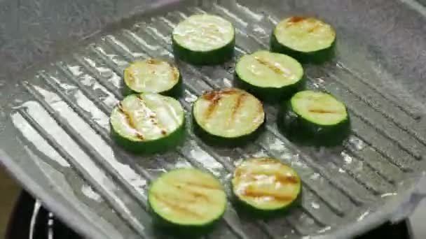 Skivor av zucchini stekt i smör på en grill panna. — Stockvideo