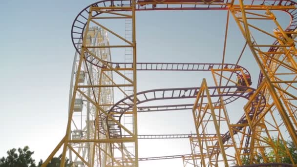Extreme roller coaster ride in an amusement park — Stock Video