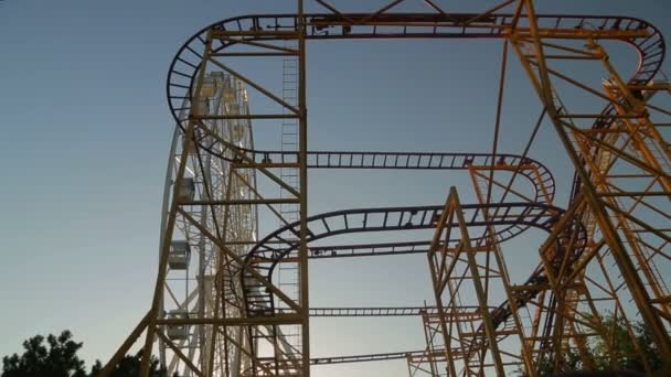 Extreme roller coaster ride in an amusement park — Stock Video