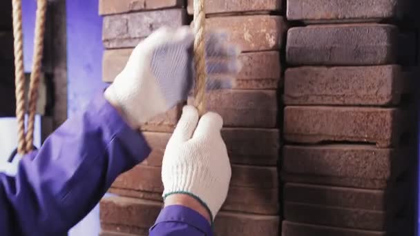 Hands of a male engineer lift a load with a cable — Stock Video