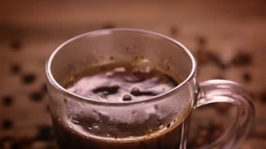 Bir kadın eli kahveye esmer şeker koyar..