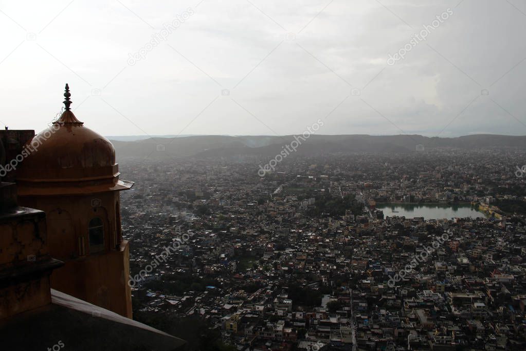 The stone railing and scenery of Jaipur city, seen from Nahargarh Fort on the hill. Taken in India, August 2018.