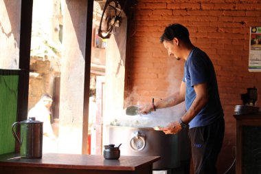 Momo, bir salonu, Güney Asya veya Tibet hamur tatlısı hizmet veren bir adam. Bhaktapur Nepal'de Ağustos 2018 alınan.