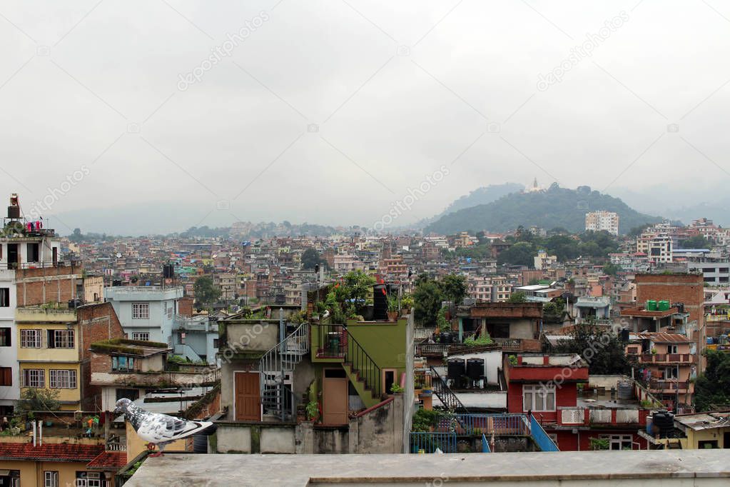 The view of Swayambhunath Stupa from the rooftop in Kathmandu during cloudy day. Taken in Nepal, August 2018.