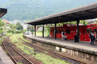 Japonya, Oita 'daki Yufuin İstasyonu' nda kırmızı tren duruyor. Haziran 2019 'da çekildi.
