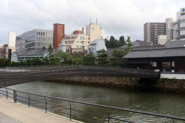 Bridge connecting Dejima of Edo period in Nagasaki by the river. Taken in August 2019. clipart