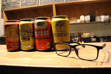 Japon bira kutularına (Kirin, Suntory, Yebisu) ve gözlüklere yakın çekim