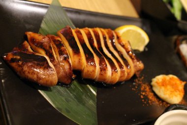 Izgara kalamar ya da balık Japon izakayasında servis edilir.
