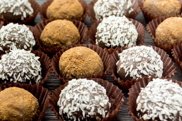 Chocolate and coconut cakes on a wooden table