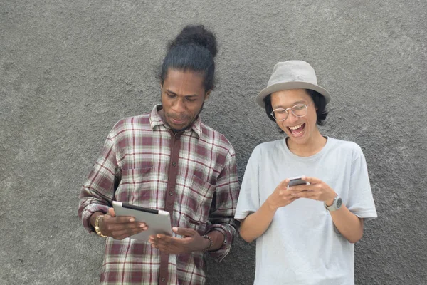 two man using smartphone, asian and black man best friend using