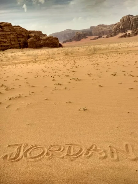 Jordan country name written in sand of Wadi rum desert