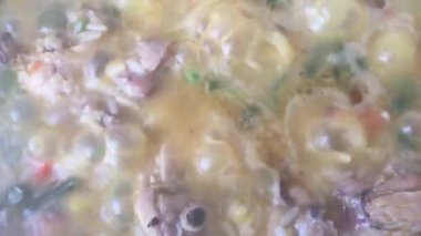 Pirinç ve tavada tavuk parçalarını kaynar