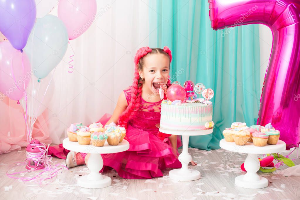 beautiful young girl celebrating her birthday and eating her cake