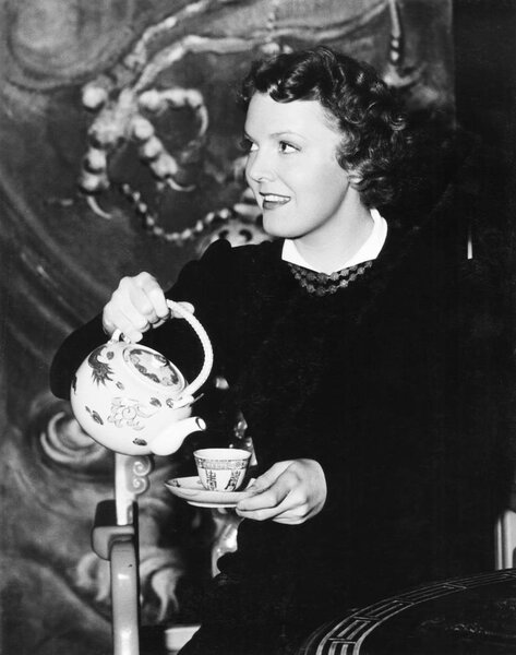 Woman pouring herself a cup of tea