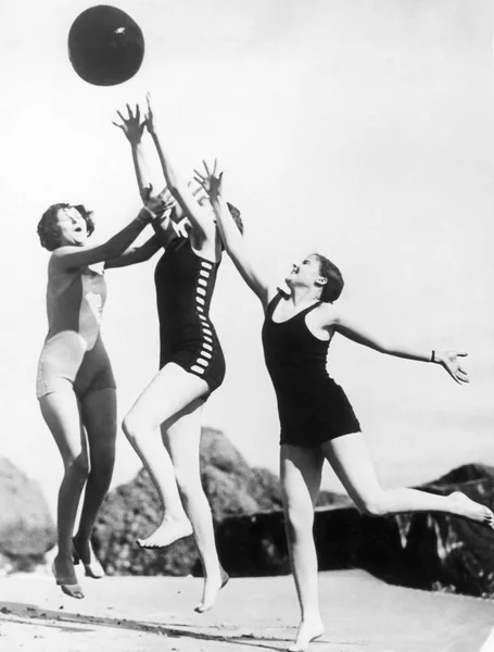 Three Woman Reaching Beach Ball Stock Image