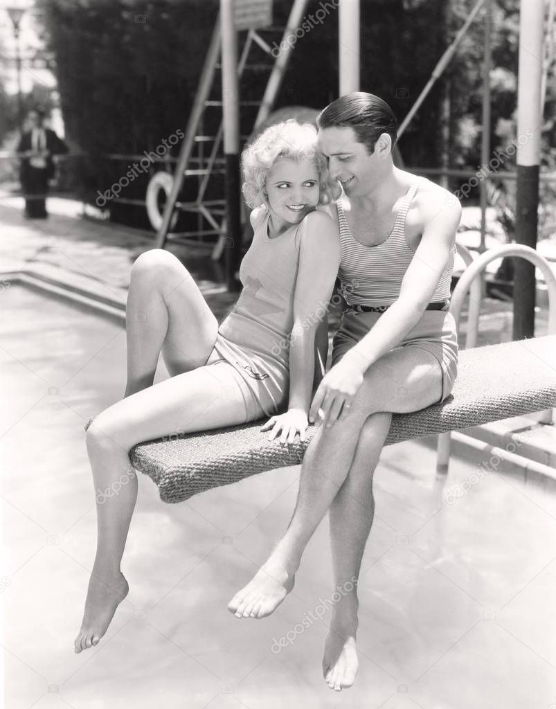 Couple flirting on a diving board