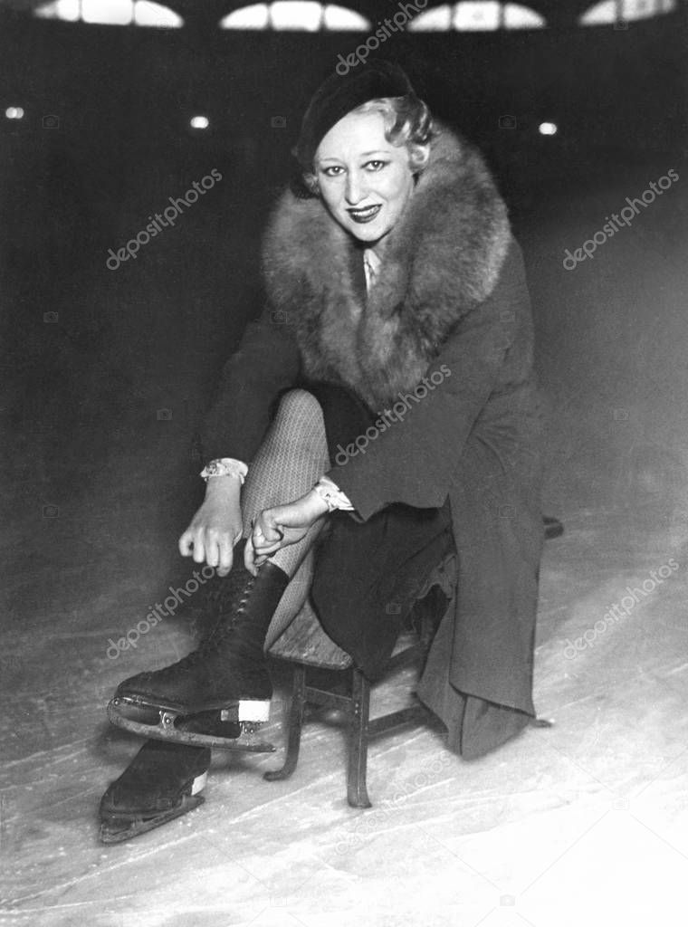 Woman putting on her ice skates