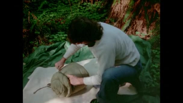 Man Tying His Sleeping Bag Forest 1970S — Stock Video
