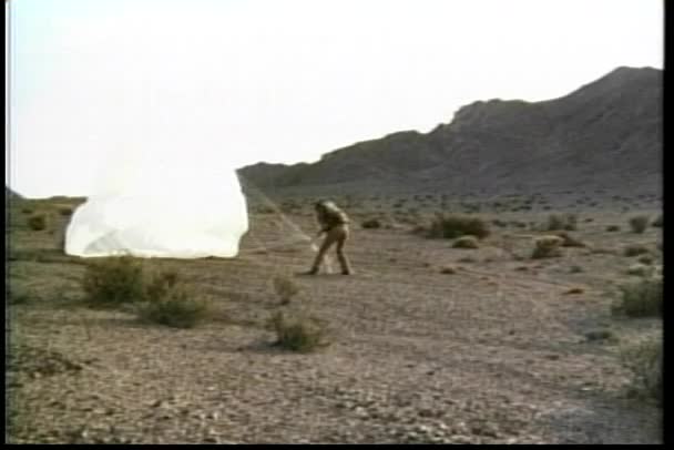 Man Packing His Parachute Landing Desert 1970S — Stock Video
