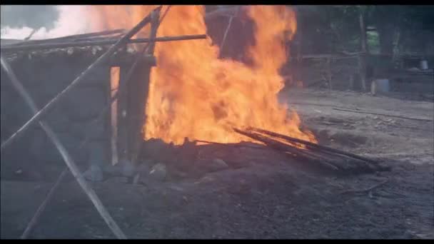 Man Fire Running Out Burning Stone Cabin 1970S — Stock Video