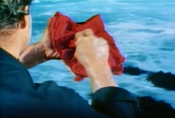 Man Unfolding Red Scarf Find Necklace 1960S — Stock Video
