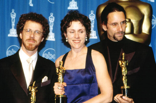THE COEN BROTHERS: Ethan (L), Joel (far right) along with their Best Actress star Frances McDormand, hold their FARGO Oscars, 3 / 24 / 97
